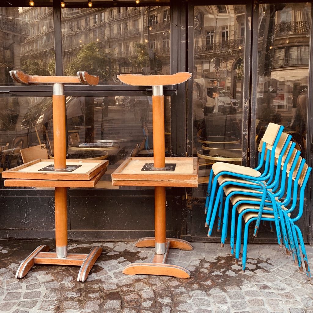 stacked tables and chairs in the street.